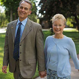 John and Pam McVay smile at the camera while holding hands