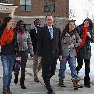 John McVay and students walk in front of the ad building in the snow